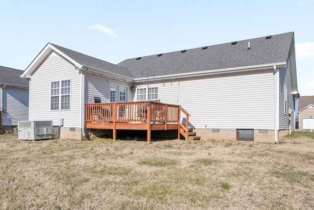 back of house featuring central AC, a deck, and a lawn