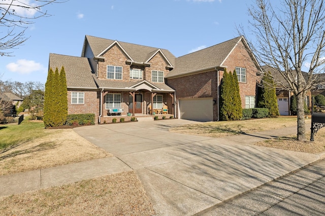 view of front facade featuring a garage, covered porch, and a front lawn