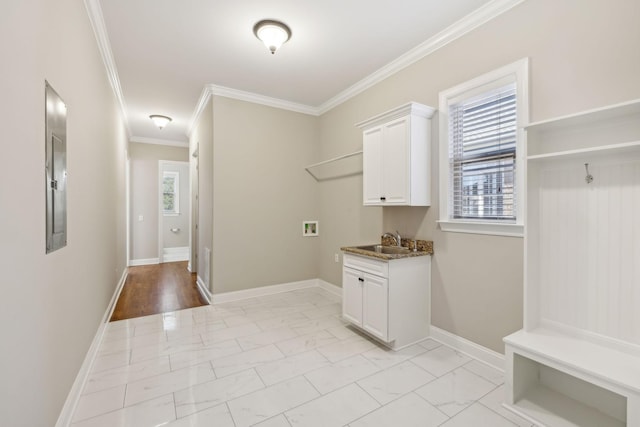 laundry area with sink, hookup for a washing machine, a wealth of natural light, and ornamental molding