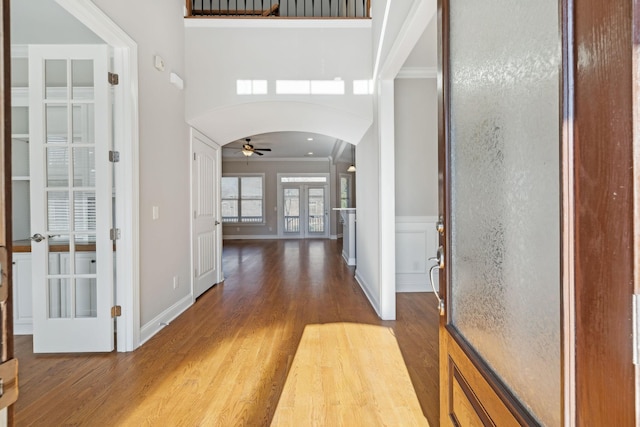 foyer entrance featuring french doors, ceiling fan, crown molding, and hardwood / wood-style floors