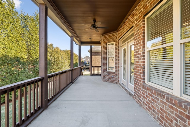 view of patio featuring ceiling fan and a balcony