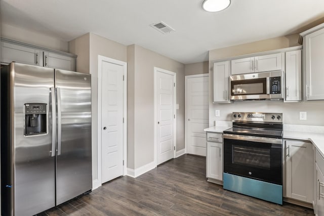 kitchen with stainless steel appliances and dark wood-type flooring