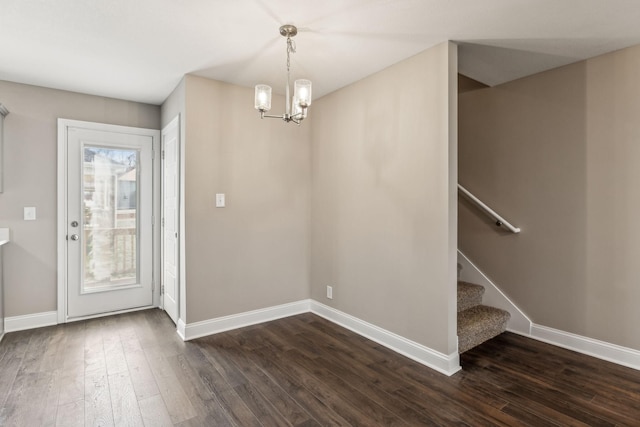 entrance foyer with an inviting chandelier and dark wood-type flooring