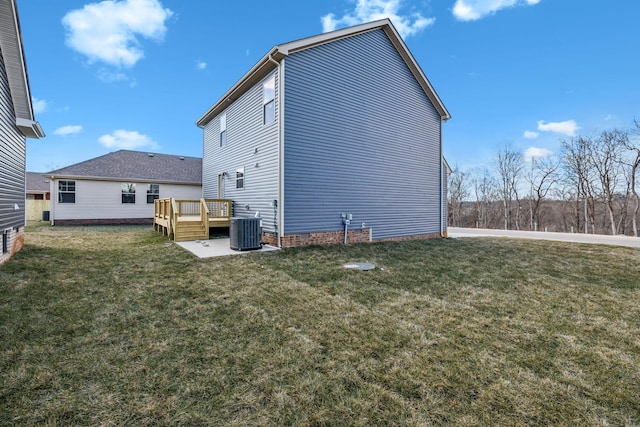 back of house featuring a wooden deck, central AC unit, and a lawn