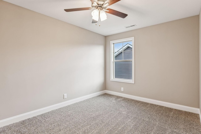 carpeted spare room with ceiling fan