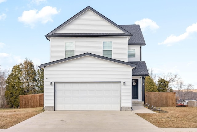 view of property featuring a garage and a front lawn