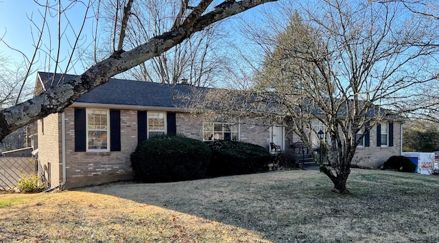 ranch-style home with a front lawn