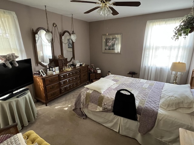 bedroom featuring light carpet and ceiling fan