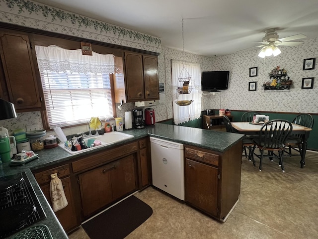 kitchen featuring dishwasher, sink, kitchen peninsula, cooktop, and dark brown cabinets