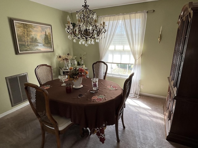 dining space featuring carpet and an inviting chandelier