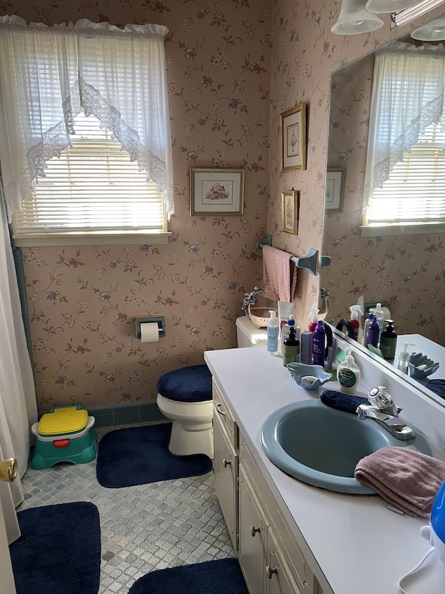 bathroom with vanity, toilet, and tile patterned flooring