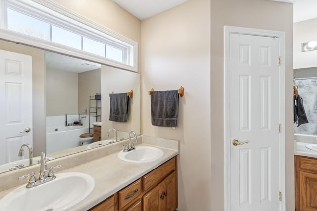 bathroom with vanity and a bath