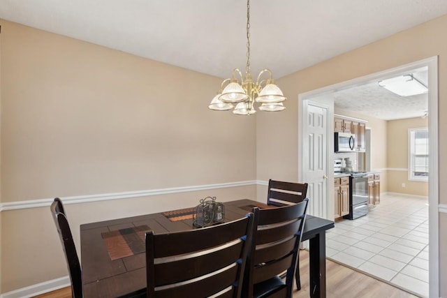 dining space featuring a chandelier and light hardwood / wood-style flooring