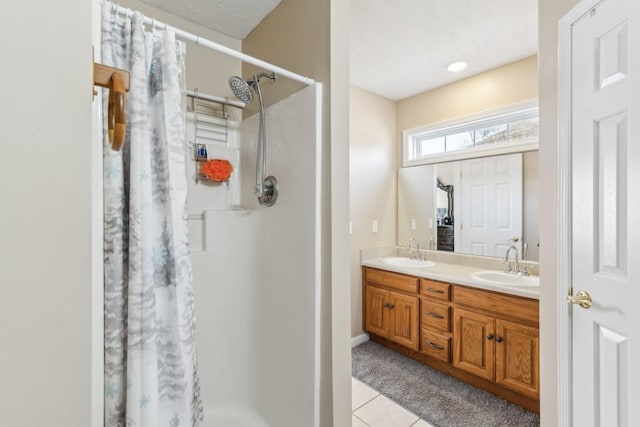 bathroom with vanity, curtained shower, and tile patterned floors