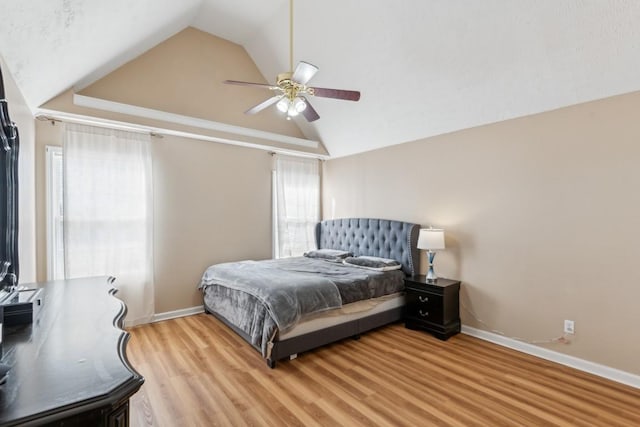 bedroom featuring ceiling fan, lofted ceiling, and light hardwood / wood-style floors