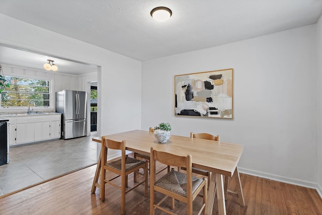 dining area with sink and light hardwood / wood-style flooring