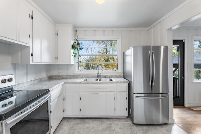 kitchen featuring white cabinetry, sink, and appliances with stainless steel finishes