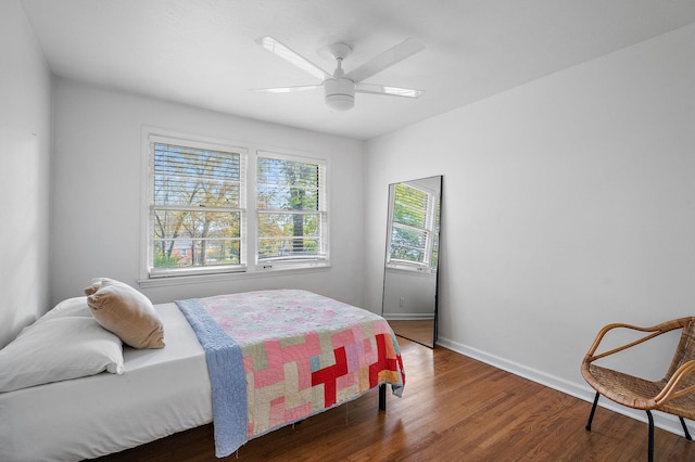 bedroom with dark wood-type flooring and ceiling fan