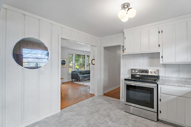 kitchen featuring white cabinetry and stainless steel electric stove