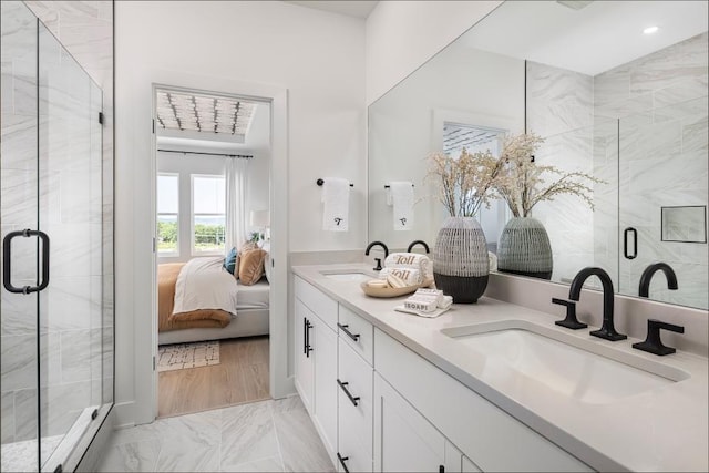 bathroom with a shower with door and vanity