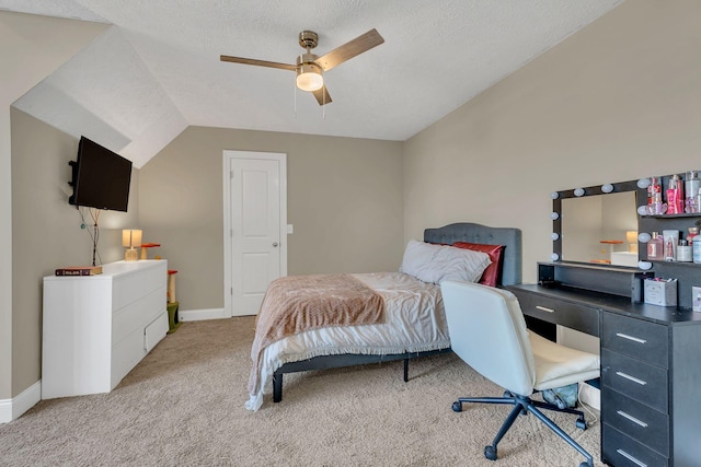 bedroom with a ceiling fan, baseboards, a textured ceiling, and light colored carpet