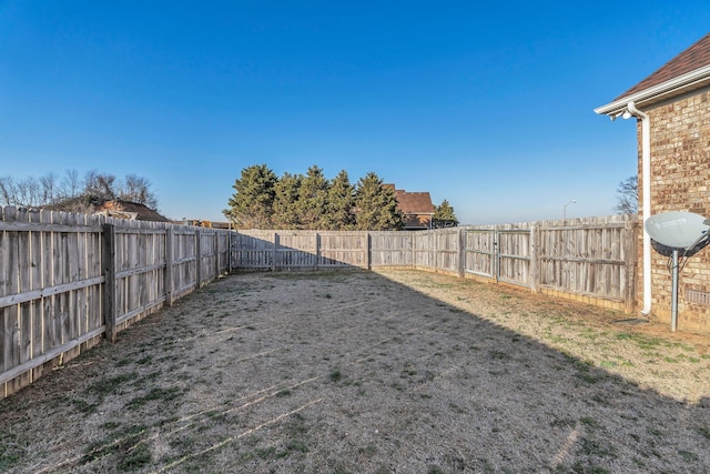 view of yard with a fenced backyard