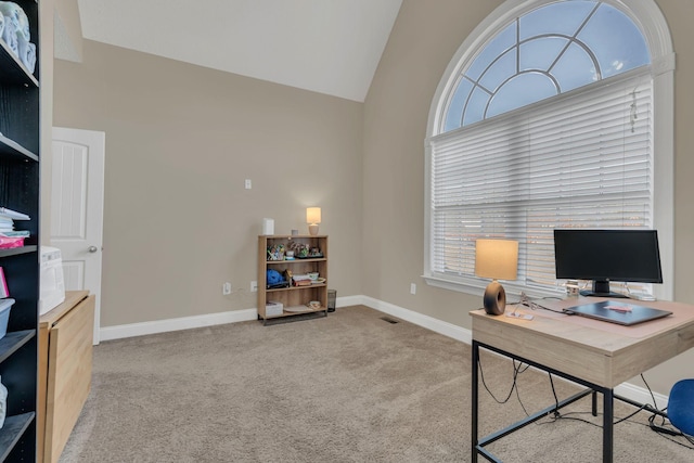 office area featuring light carpet, high vaulted ceiling, visible vents, and baseboards