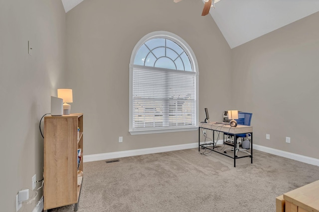 office area featuring lofted ceiling, a healthy amount of sunlight, light colored carpet, and visible vents