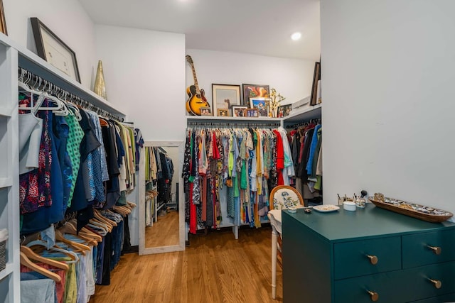 walk in closet with light hardwood / wood-style flooring