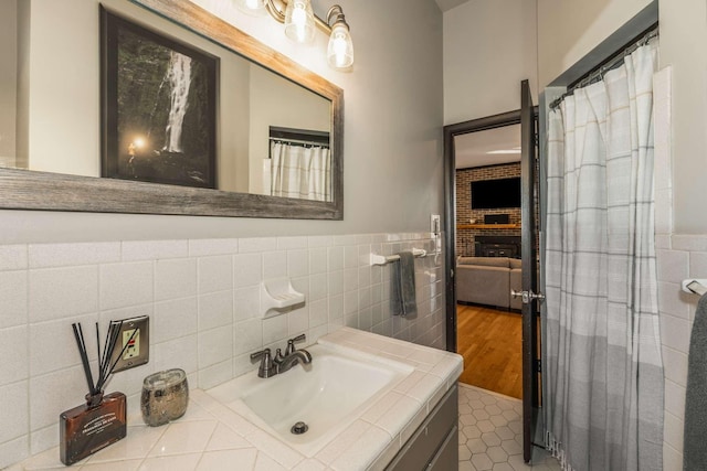 bathroom with tile patterned floors, tile walls, and vanity