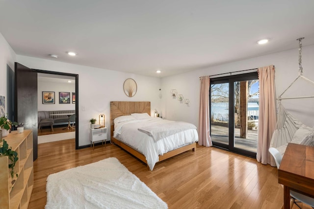 bedroom featuring hardwood / wood-style floors and access to outside