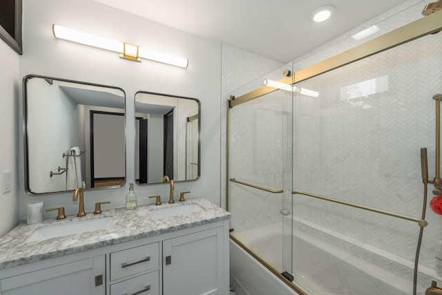 bathroom featuring vanity and bath / shower combo with glass door