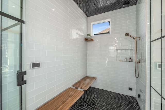 bathroom with tiled shower