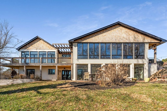 back of house with a patio and a lawn