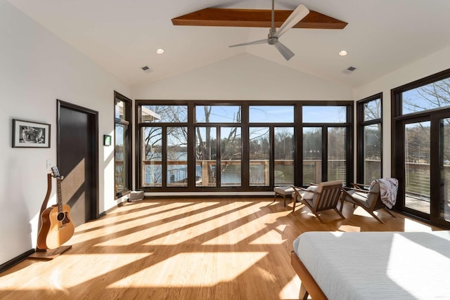 sunroom / solarium featuring a wealth of natural light and lofted ceiling with beams