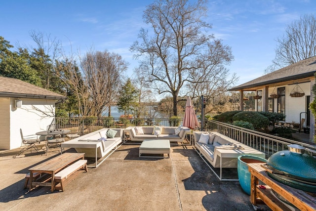 view of patio with an outdoor living space with a fire pit