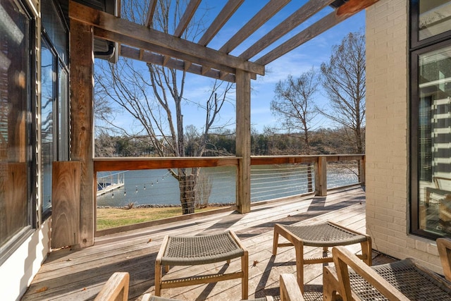 wooden terrace featuring a water view