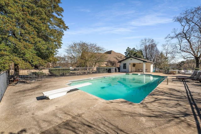 view of pool featuring a diving board and a patio area