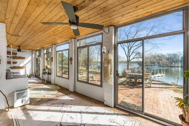 unfurnished sunroom featuring a water view, ceiling fan, and wood ceiling