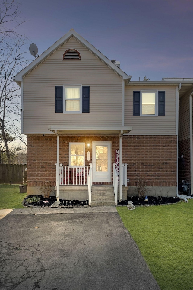 view of front facade with a porch and a yard