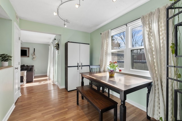 dining space with light wood-type flooring