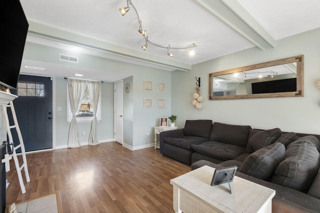 living room with hardwood / wood-style floors and beam ceiling