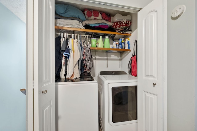 clothes washing area featuring a textured ceiling and washing machine and clothes dryer