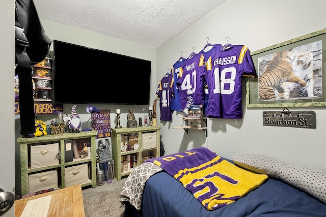 bedroom featuring carpet floors and a textured ceiling