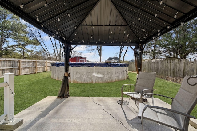 view of patio featuring a gazebo and a covered pool