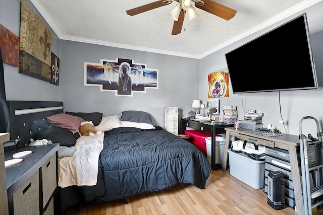 bedroom with crown molding, light hardwood / wood-style floors, ceiling fan, and a textured ceiling