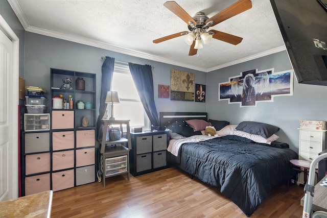 bedroom featuring crown molding, ceiling fan, and a textured ceiling