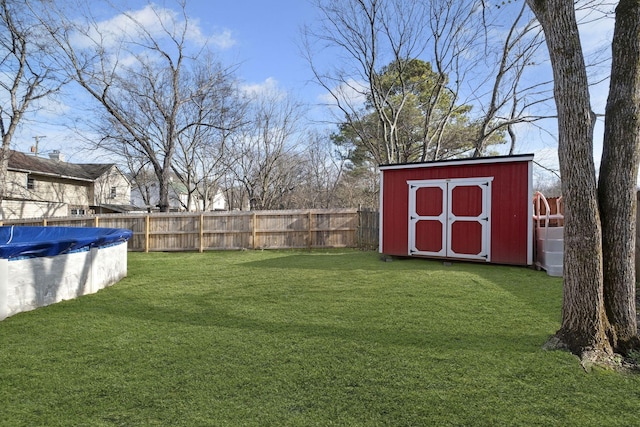 view of yard with a storage unit and a covered pool