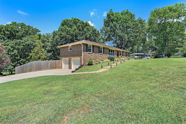 view of front of home with a garage and a front lawn