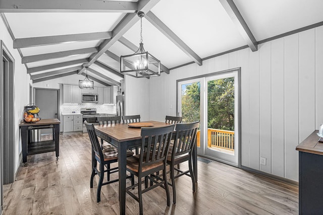 dining space with vaulted ceiling with beams, a chandelier, and light hardwood / wood-style flooring